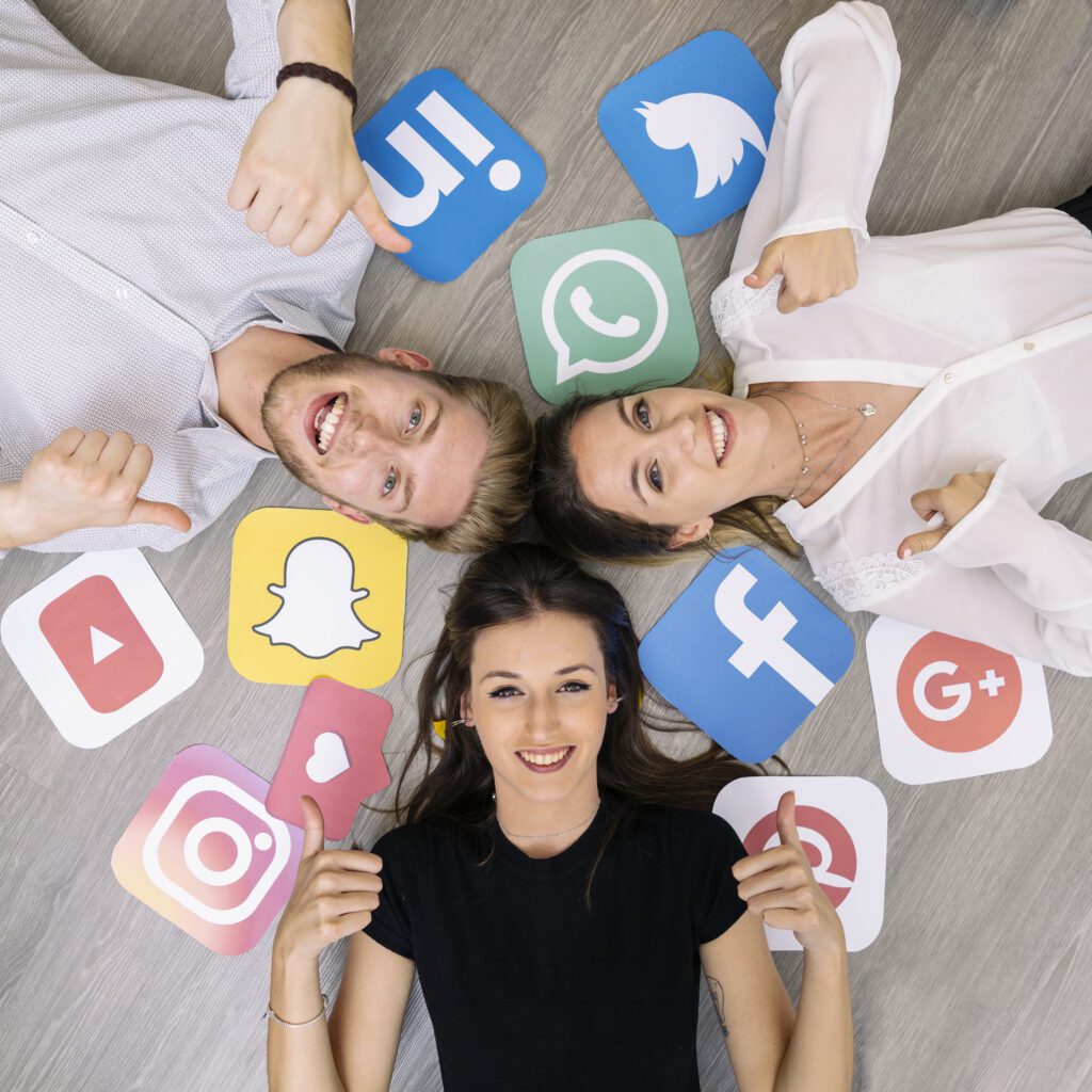 Young people lying on floor with social media icons